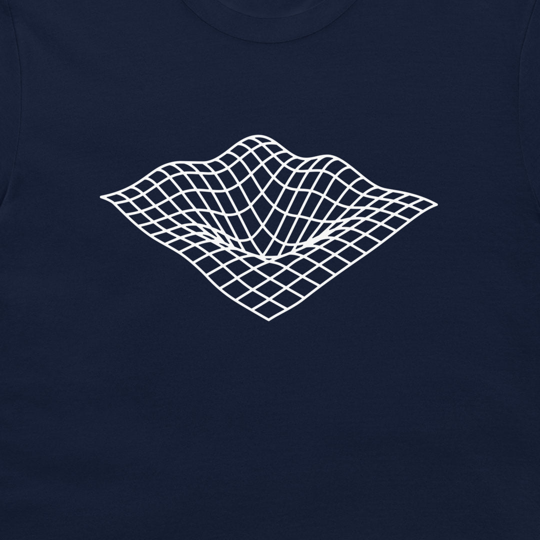 A close-up of a navy blue t-shirt featuring a white 3D wireframe grid graphic on the chest, representing a classic digital art surface tension effect.