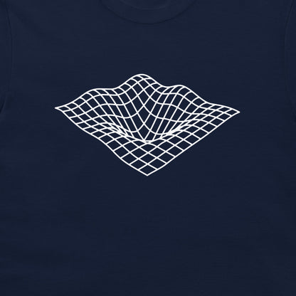 A close-up of a navy blue t-shirt featuring a white 3D wireframe grid graphic on the chest, representing a classic digital art surface tension effect.