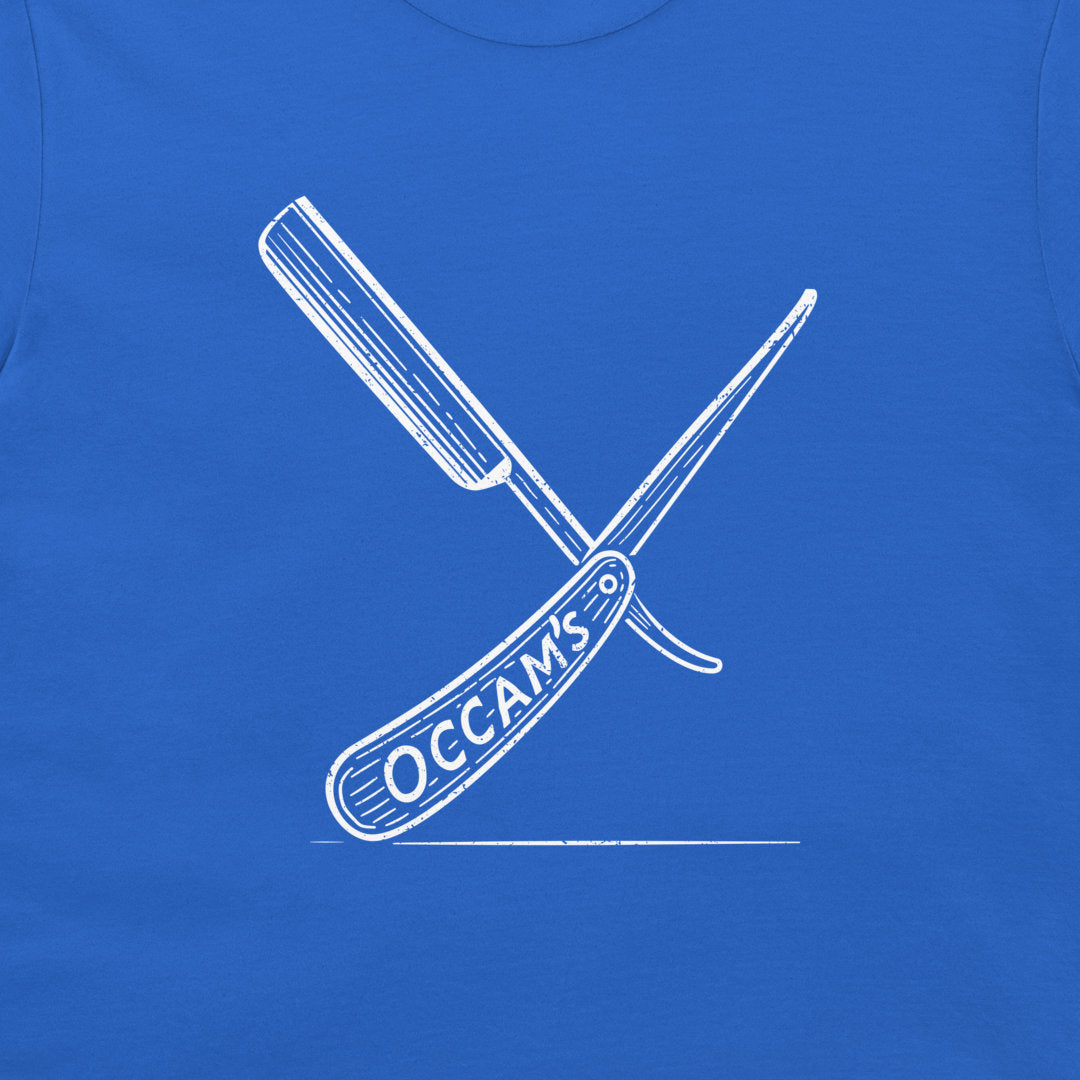 A close-up of a royal blue garment, likely a t-shirt, featuring a white graphic of two crossed folding knives with the text 'OCCAM'S' on the handle.