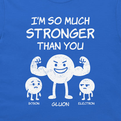 A close-up of a blue t-shirt featuring a white distressed graphic of three cartoon particles labeled 'BOSON', 'GLUON', and 'ELECTRON' with the text 'I'M SO MUCH STRONGER THAN YOU'.