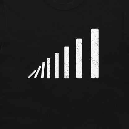 A close-up of a minimal domino effect T-shirt – white falling domino sequence in perspective, clean geometric design on black shirt.