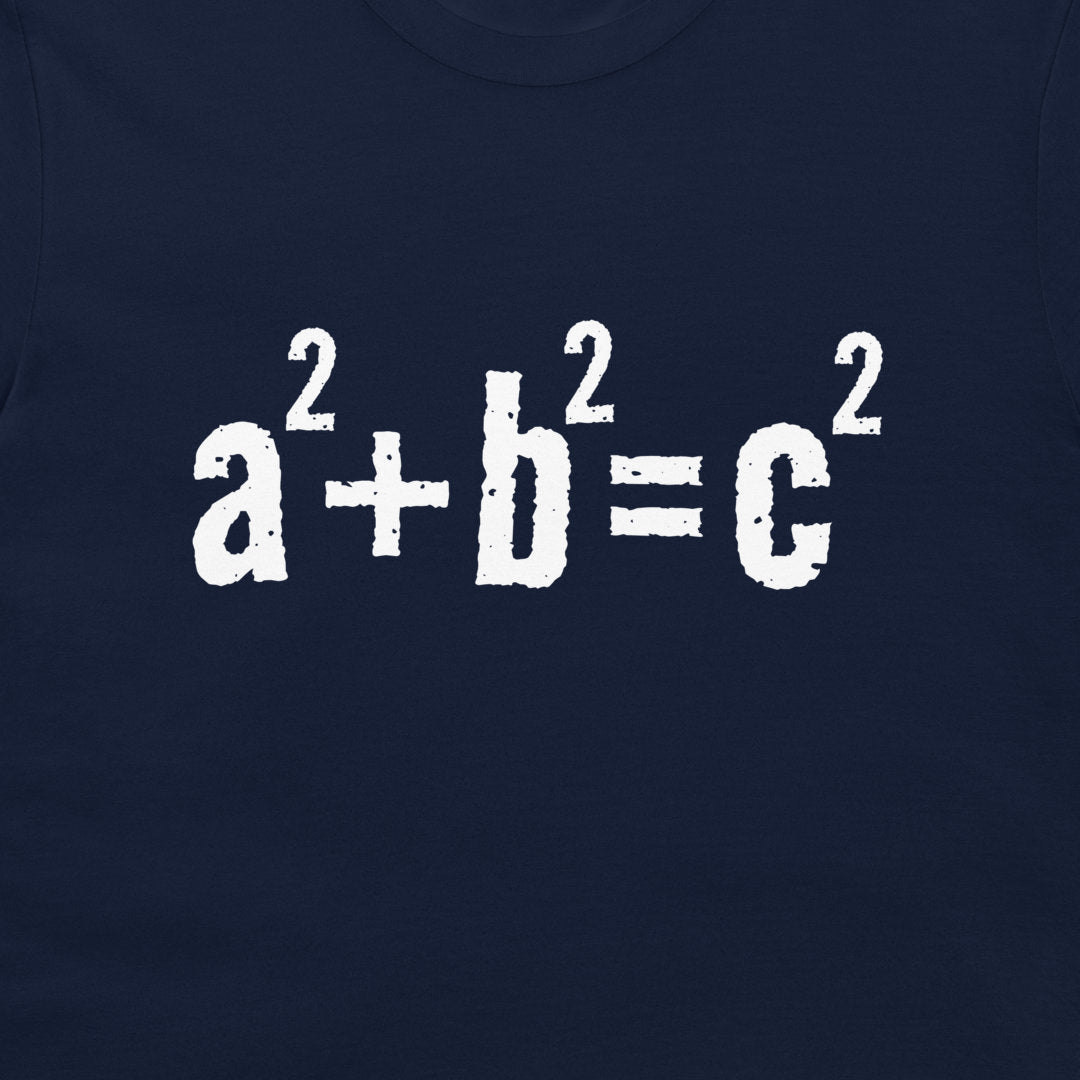 A close-up of a navy blue garment, likely a t-shirt, featuring the mathematical equation 'a² + b² = c²' printed in a distressed white font across the chest.