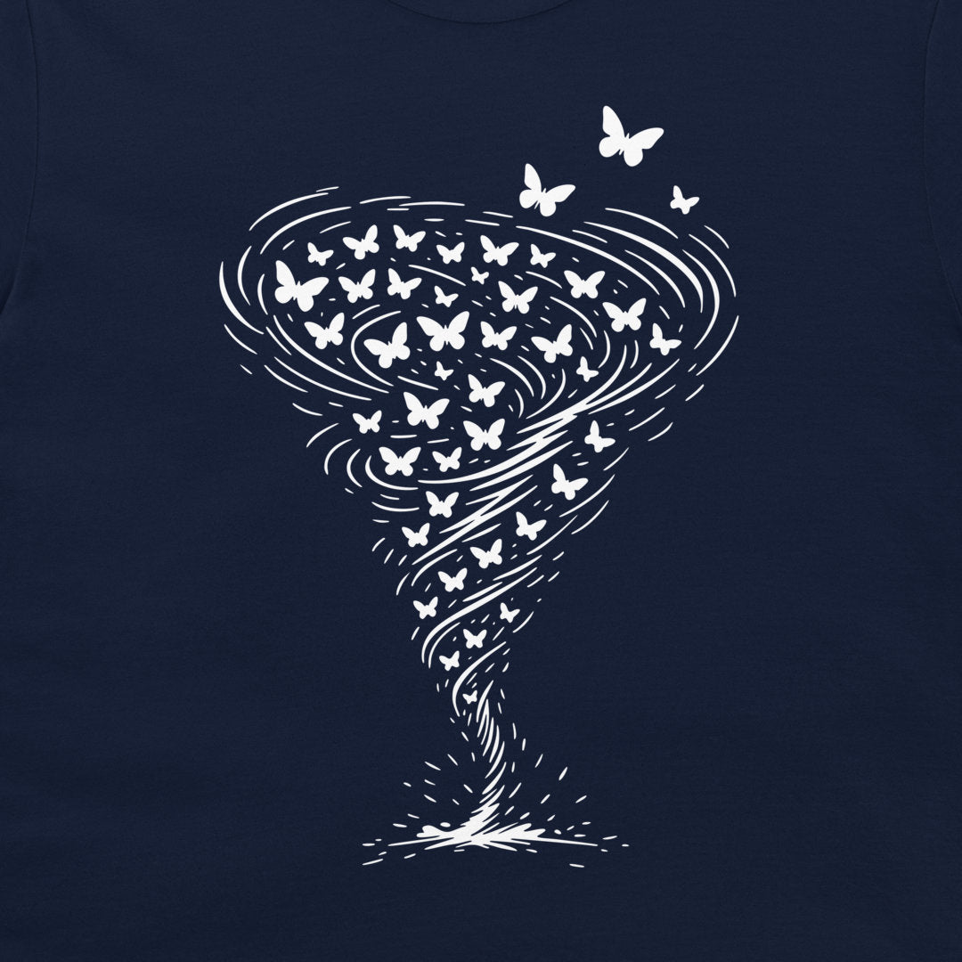 A close-up of a navy blue t-shirt, featuring a white graphic print of a tornado made of swirling lines and butterflies.