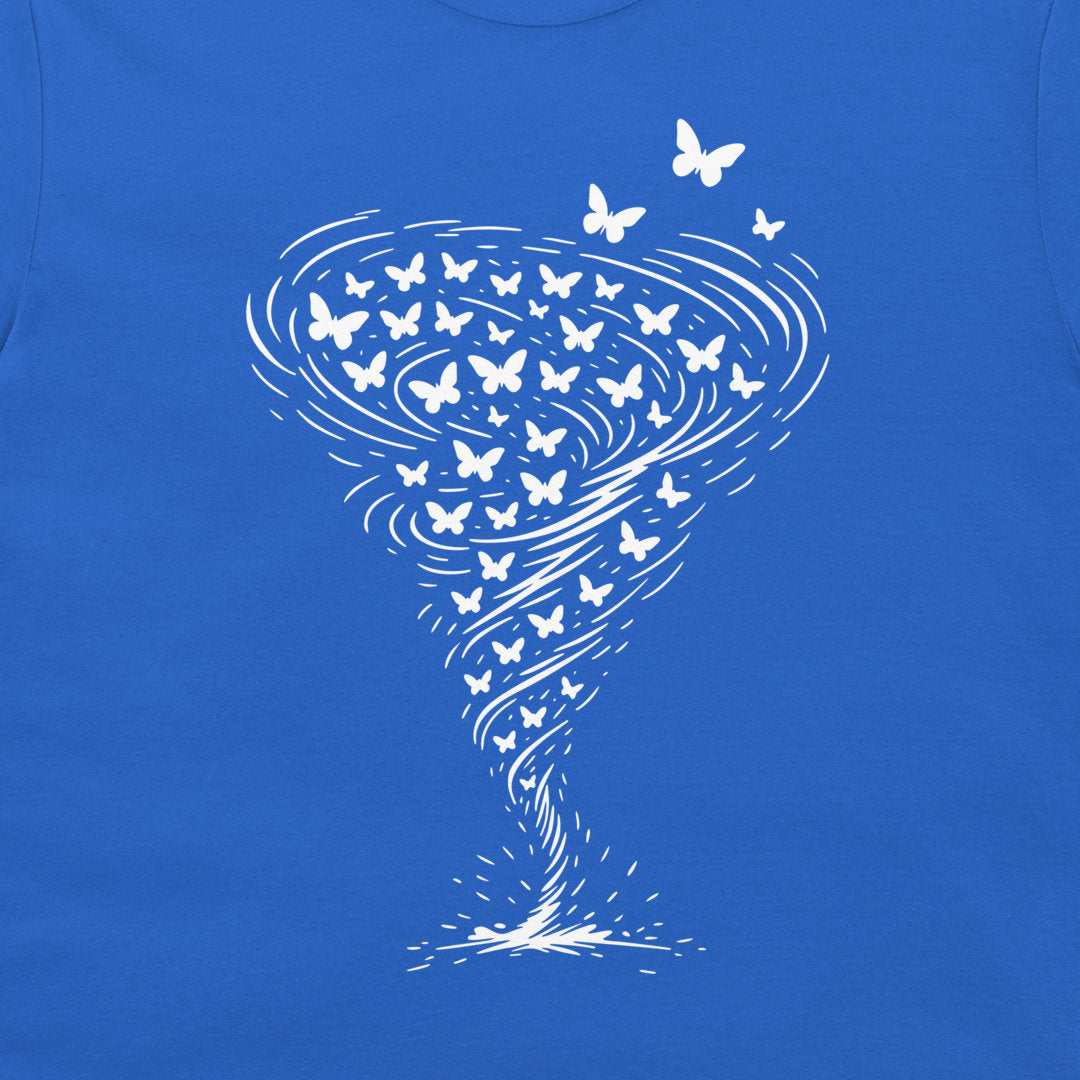 A close-up of a royal blue t-shirt, featuring a white graphic print of a tornado made of swirling lines and numerous small butterflies.