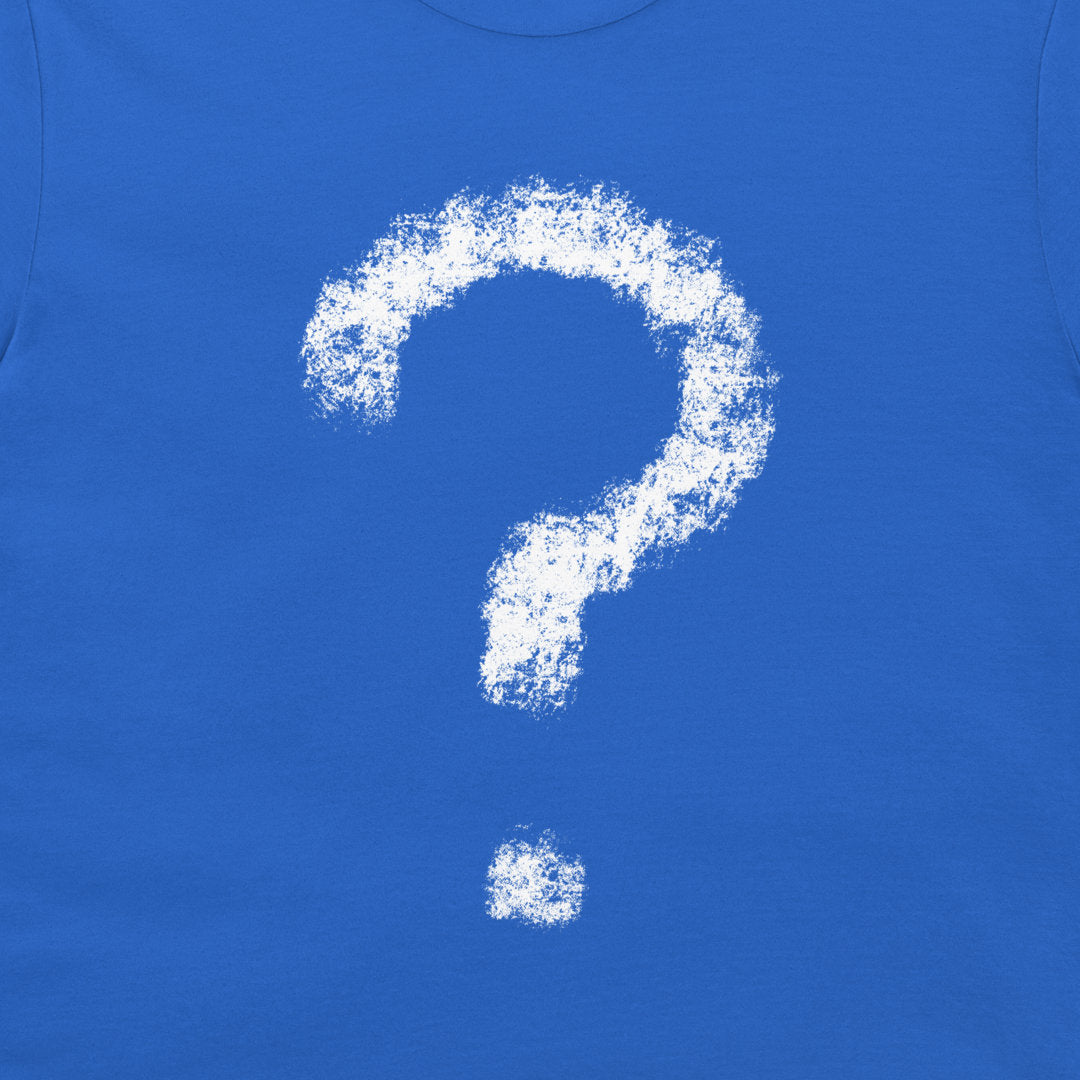 A close-up of a bright blue T-shirt, featuring a large white chalk-style question mark graphic on the chest and a small matching dot below it.