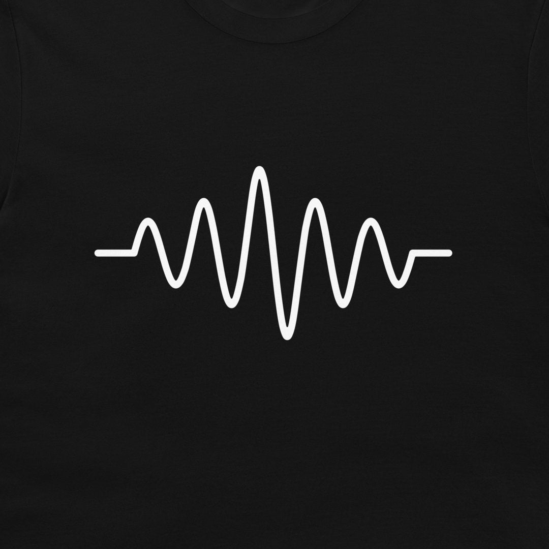 A close-up of a black garment, likely a t-shirt, featuring a white continuous soundwave or heartbeat-style graphic printed across the chest.