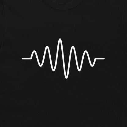 A close-up of a black garment, likely a t-shirt, featuring a white continuous soundwave or heartbeat-style graphic printed across the chest.