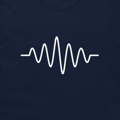 A close-up of a navy blue garment, likely a t-shirt, featuring a white graphic of an audio waveform or heartbeat line printed across the chest.