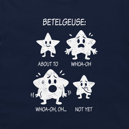A close-up of a navy blue t-shirt, featuring a white distressed graphic print of four cartoon stars with humorous expressions and text labels: 'BETELGEUSE:', 'ABOUT TO', 'WHOA-OH', 'WHOA-OH, OH...', 'NOT YET'.
