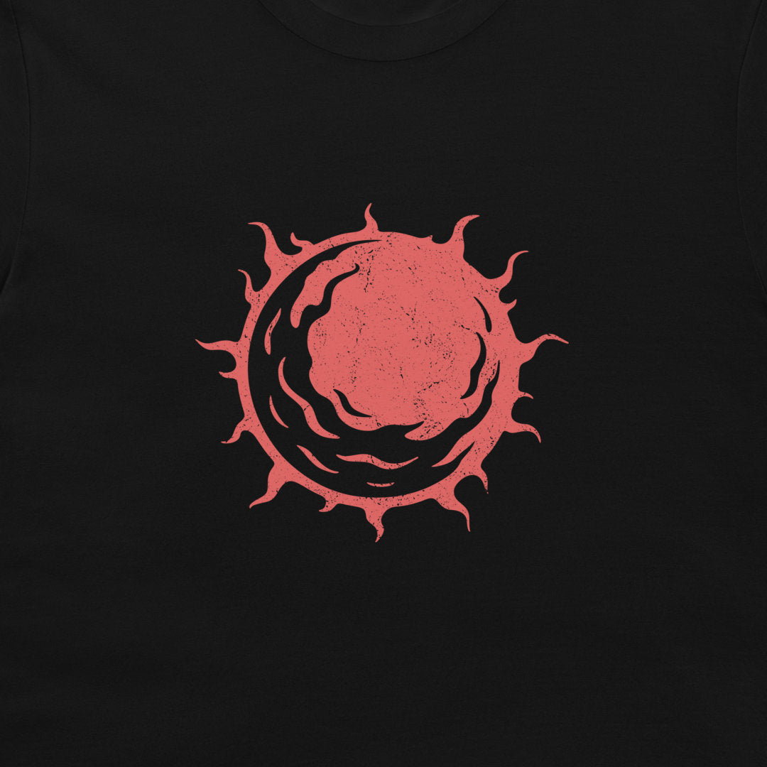 A close-up of a black t-shirt featuring a distressed red circular graphic osf a star on the chest.