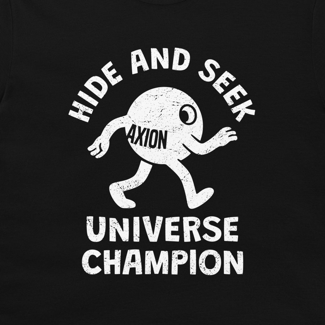 A close-up of a black t-shirt, featuring a distressed white graphic print. The design shows a cartoon character labeled 'AXION' with the text 'HIDE AND SEEK' above and 'UNIVERSE CHAMPION' below.