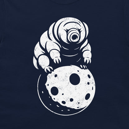 A close-up of a navy blue t-shirt, featuring a distressed white graphic of a tardigrade crawling on a cratered moon.