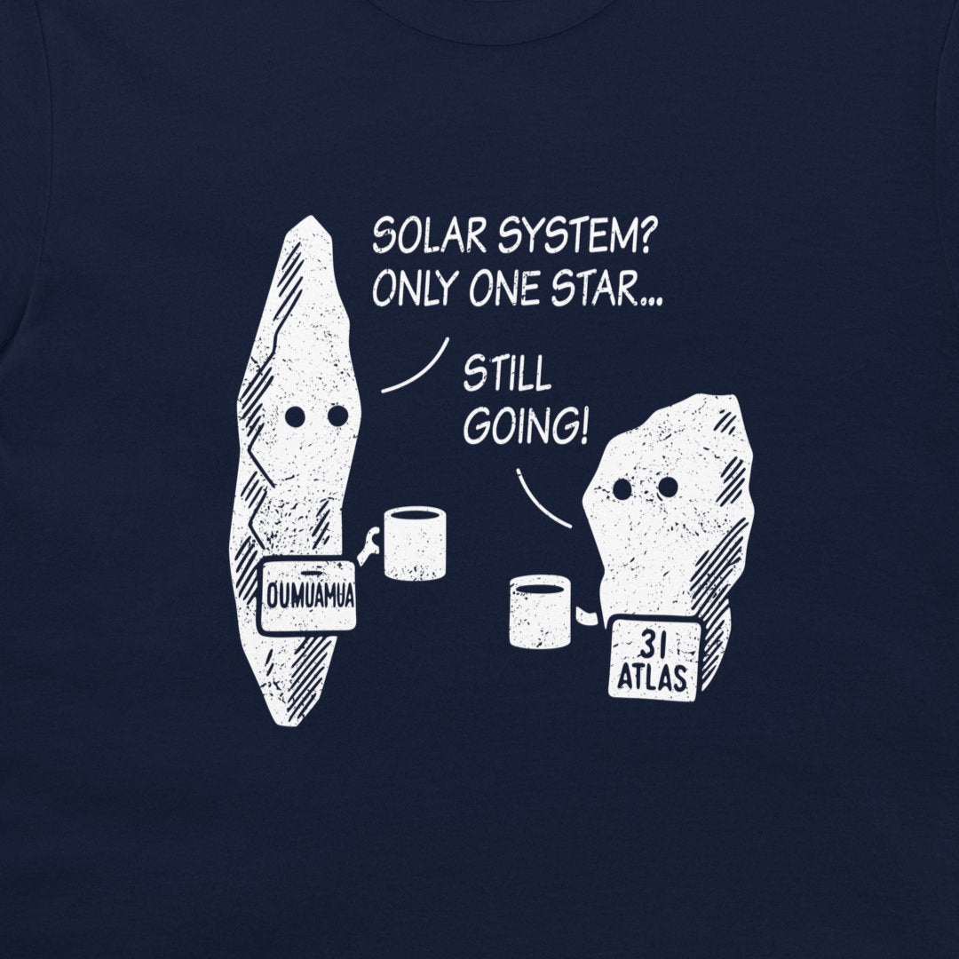 A close-up of a navy blue t-shirt featuring a white graphic print of two cartoon asteroids with text that reads 'SOLAR SYSTEM? ONLY ONE STAR.