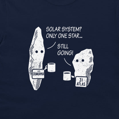 A close-up of a navy blue t-shirt featuring a white graphic print of two cartoon asteroids with text that reads 'SOLAR SYSTEM? ONLY ONE STAR.