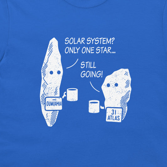A close-up of a royal blue t-shirt featuring a white graphic print of two asteroids, labeled 'OUMIUMHUA' and '31 ATLAS', with the text 'SOLAR SYSTEM? ONLY ONE STAR.