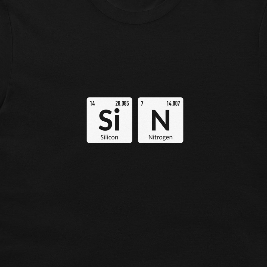 A close-up of a black t-shirt featuring a graphic print of two white periodic table tiles spelling out 'SiN' with 'Silicon' and 'Nitrogen' written underneath.