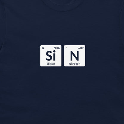 A close-up of a navy blue t-shirt featuring a graphic print of two white periodic table tiles spelling out 'SiN' with 'Silicon' and 'Nitrogen' written underneath.
