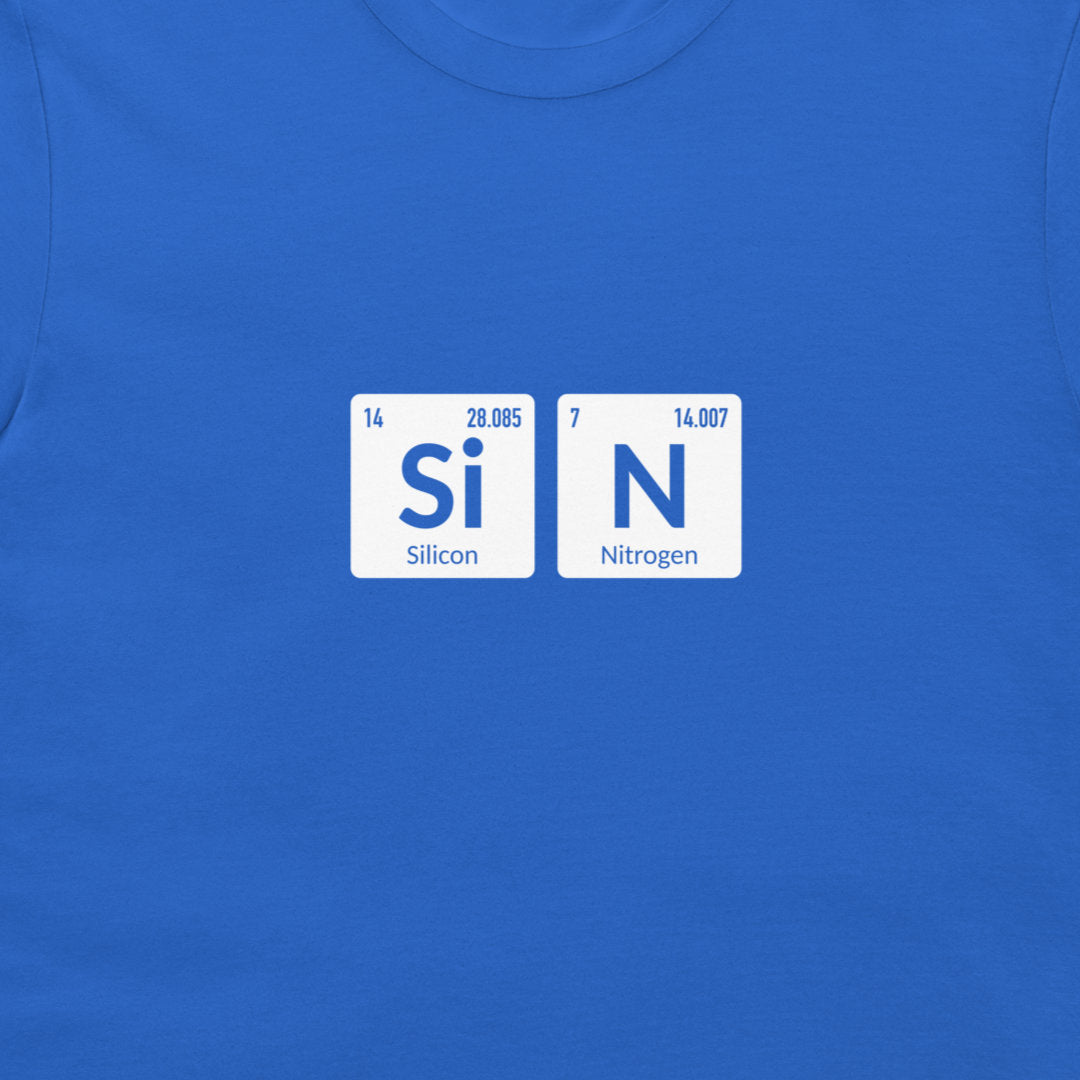 A close-up of a royal blue t-shirt featuring a graphic of two white periodic table tiles spelling out 'SiN' with 'Silicon' and 'Nitrogen' written underneath.