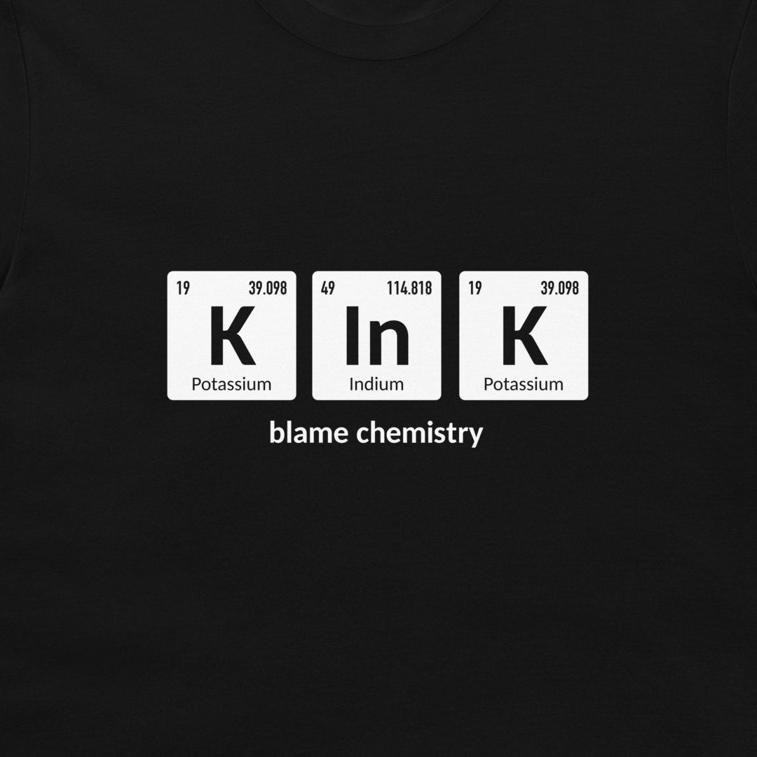 A black crewneck t-shirt featuring a white graphic of three periodic table style tiles spelling 'K In K' with the text 'blame chemistry' underneath.
