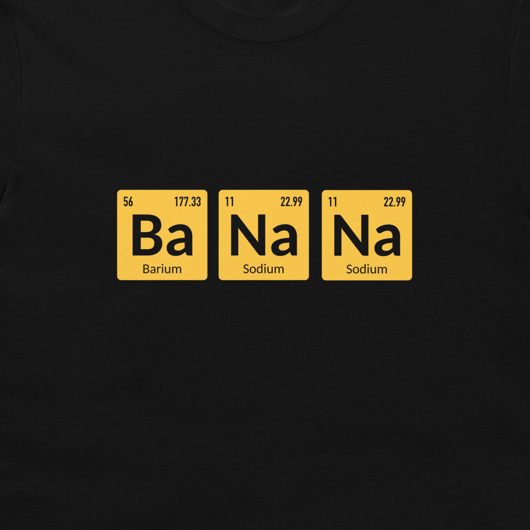 A close-up of a black t-shirt, featuring a graphic of three yellow periodic table-style tiles spelling out 'Ba Na Na' in black text.