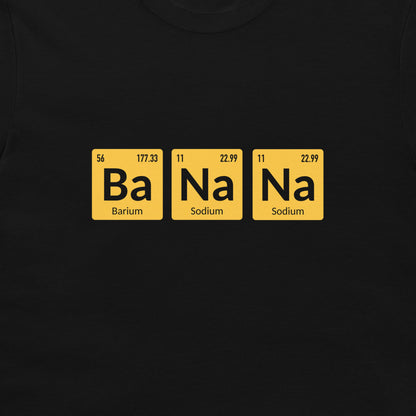 A close-up of a black t-shirt, featuring a graphic of three yellow periodic table-style tiles spelling out 'Ba Na Na' in black text.
