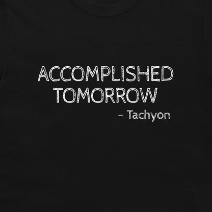 A close-up of a black t-shirt featuring the text 'ACCOMPLISHED TOMORROW - Tachyon' printed in a white, chalk-like distressed font.