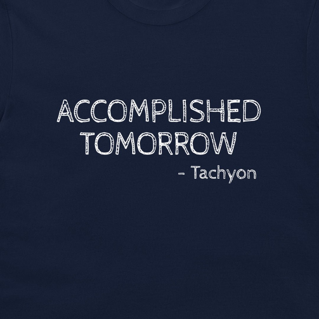 A close-up of a navy blue t-shirt featuring the text 'ACCOMPLISHED TOMORROW - Tachyon' printed in a white, distressed font on the chest.