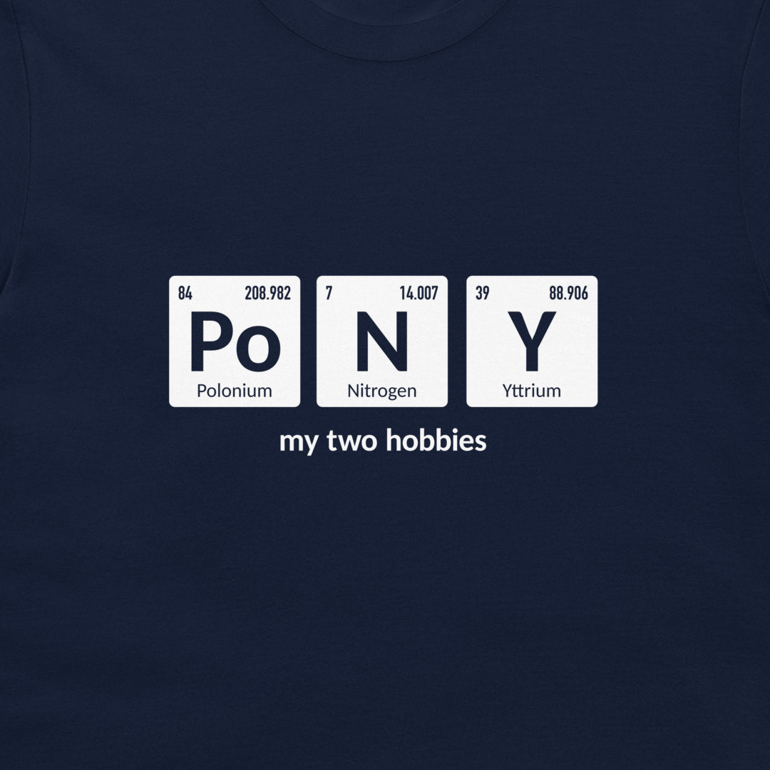 A close-up of a navy blue t-shirt featuring a white graphic that spells 'PoNY' using periodic table style tiles, with 'my two hobbies' printed below.