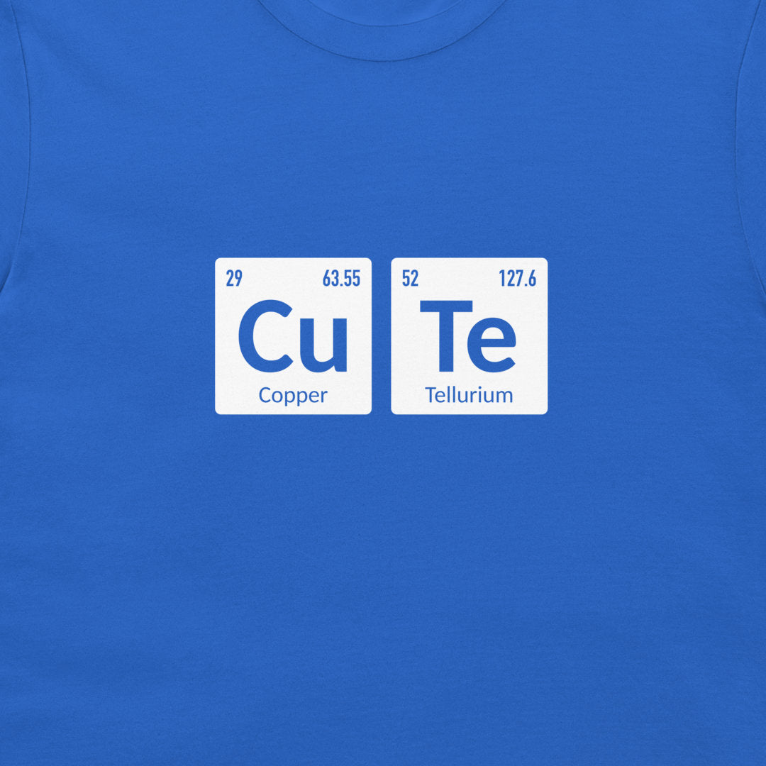 A close-up of a royal blue t-shirt featuring a graphic print of two white periodic table style tiles spelling out 'Cu Te' with 'Copper' and 'Tellurium' underneath.