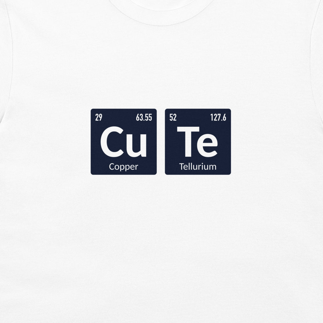 A close-up of a white t-shirt, featuring a graphic print of two dark blue periodic table style tiles spelling out 'CuTe' with 'Copper' and 'Tellurium' written below.