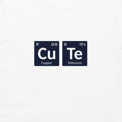 A close-up of a white t-shirt, featuring a graphic print of two dark blue periodic table style tiles spelling out 'CuTe' with 'Copper' and 'Tellurium' written below.