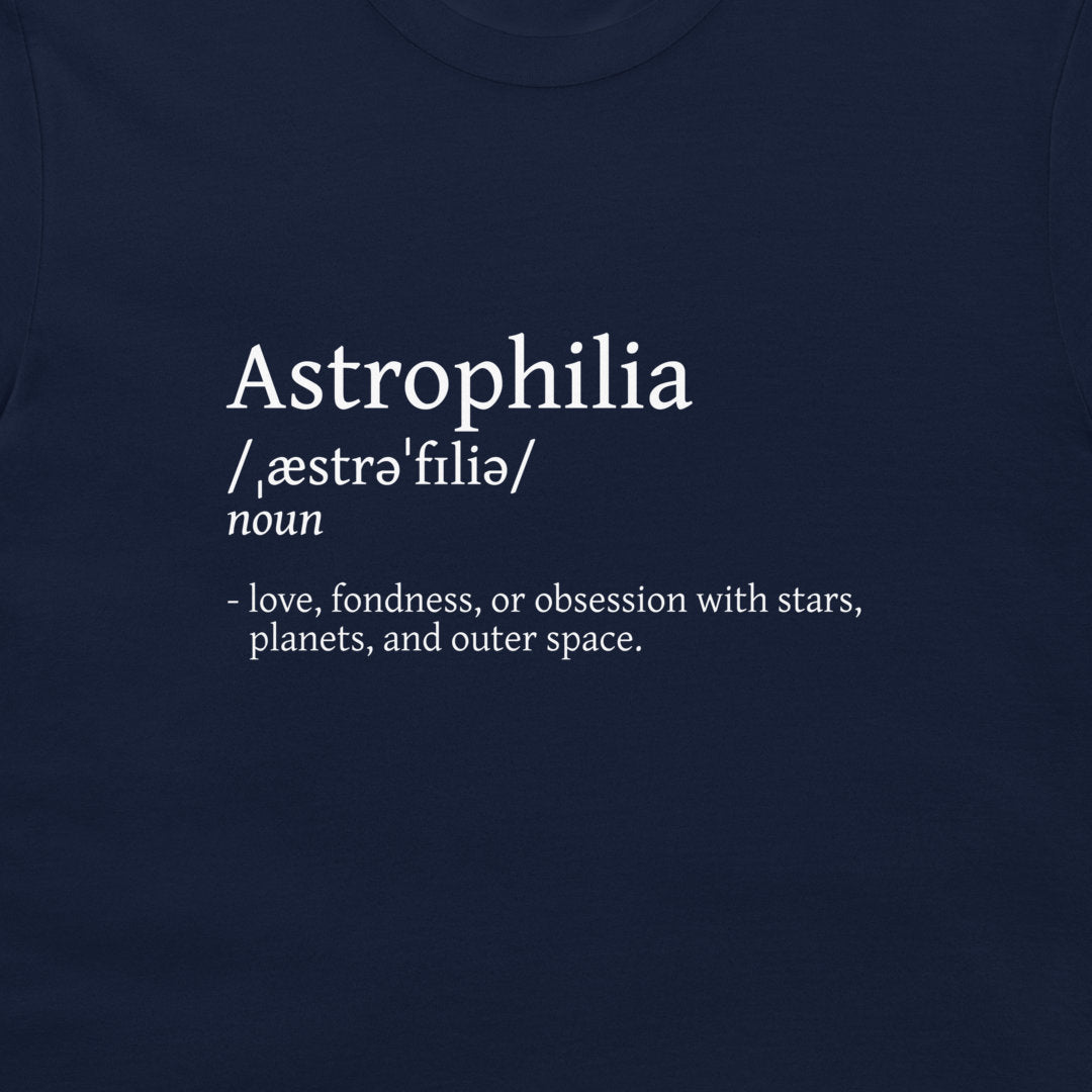 A close-up of a navy blue t-shirt featuring a white printed dictionary-style definition for the word 'Astrophilia'.