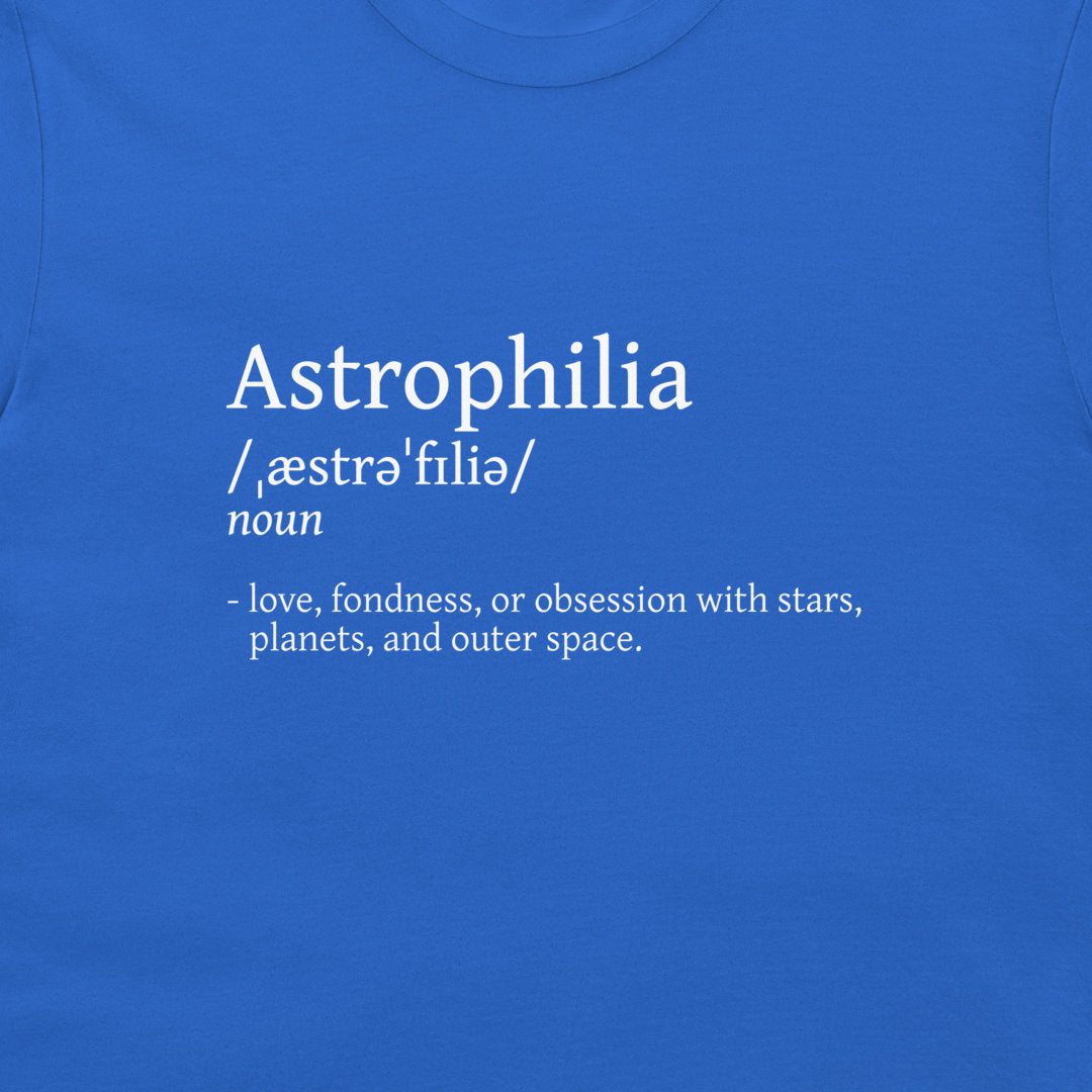 A close-up of a blue T-shirt with white printed text defining the word 'Astrophilia' and its pronunciation.