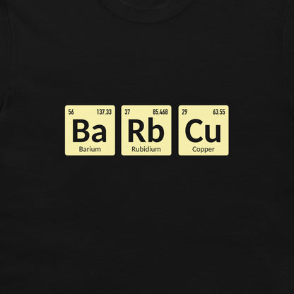 A close-up of a black t-shirt, featuring a graphic of three periodic table tiles spelling out 'Ba Rb Cu' in black text on pale yellow rectangular backgrounds.