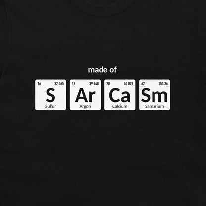 A black crewneck t-shirt featuring a graphic print of four white periodic table element tiles spelling out 'made of' with 'S', 'Ar', 'Ca', and 'Sm' and their respective symbols and chemical names.