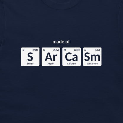 A navy blue crewneck t-shirt featuring a graphic print of four white periodic table element tiles spelling out 'made of' with 'S', 'Ar', 'Ca', and 'Sm' and their respective symbols and chemical names.