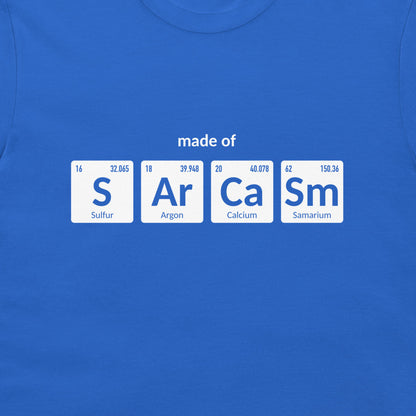 A royal blue crewneck t-shirt featuring a graphic print of four white periodic table element tiles spelling out 'made of' with 'S', 'Ar', 'Ca', and 'Sm' and their respective symbols and chemical names.