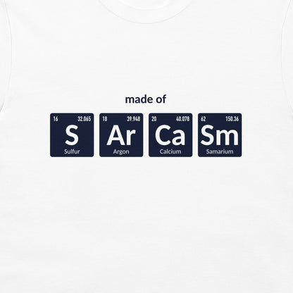 A white crewneck t-shirt featuring a graphic print of four dark blue periodic table element tiles spelling out 'made of' with 'S', 'Ar', 'Ca', and 'Sm' and their respective symbols and chemical names.