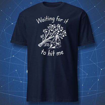 A navy blue t-shirt, featuring a white graphic print of a historical figure sitting under an apple tree with the text 'Waiting for it to hit me'.