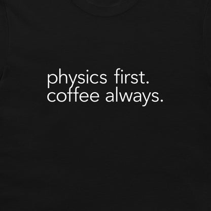 A close-up of a black t-shirt featuring the phrase 'physics first. 