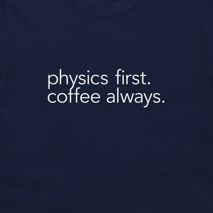 A close-up of a navy blue t-shirt featuring the phrase 'physics first. coffee always.