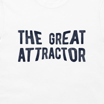 White t-shirt featuring the phrase 'THE GREAT ATTRACTOR' printed in a dark navy blue textured font across the chest.