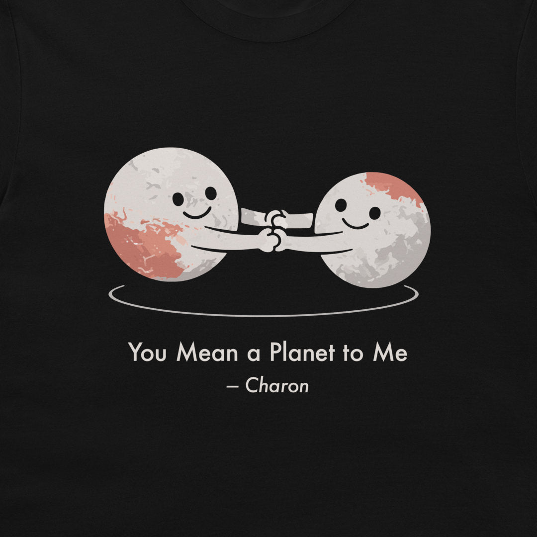 A black t-shirt featuring a graphic of two smiling cartoon celestials holding hands, with the text 'You Mean a Planet to Me - Charon' printed below in white.