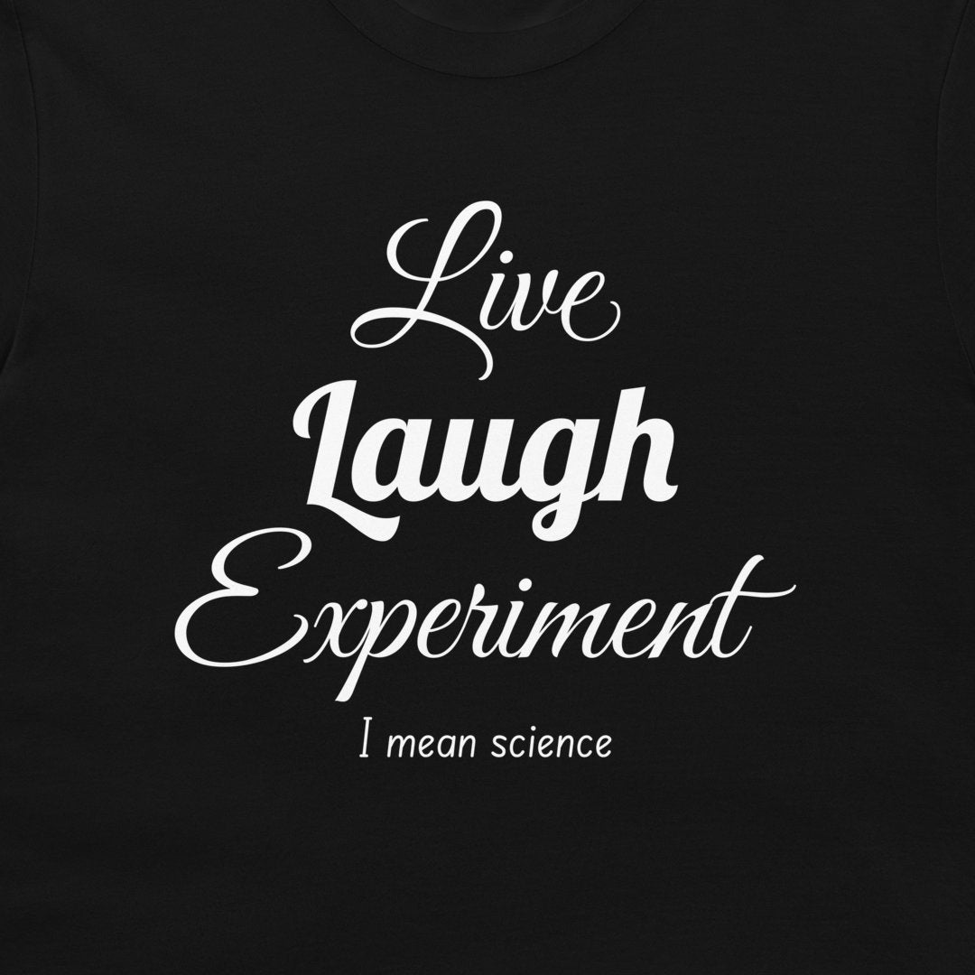 A close-up of a black t-shirt featuring a white printed graphic that reads 'Live Laugh Experiment I mean science' in stylized fonts.