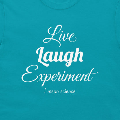 A close-up of a teal t-shirt featuring a white printed graphic that reads 'Live Laugh Experiment' in stylized fonts, with 'I mean science' written underneath.