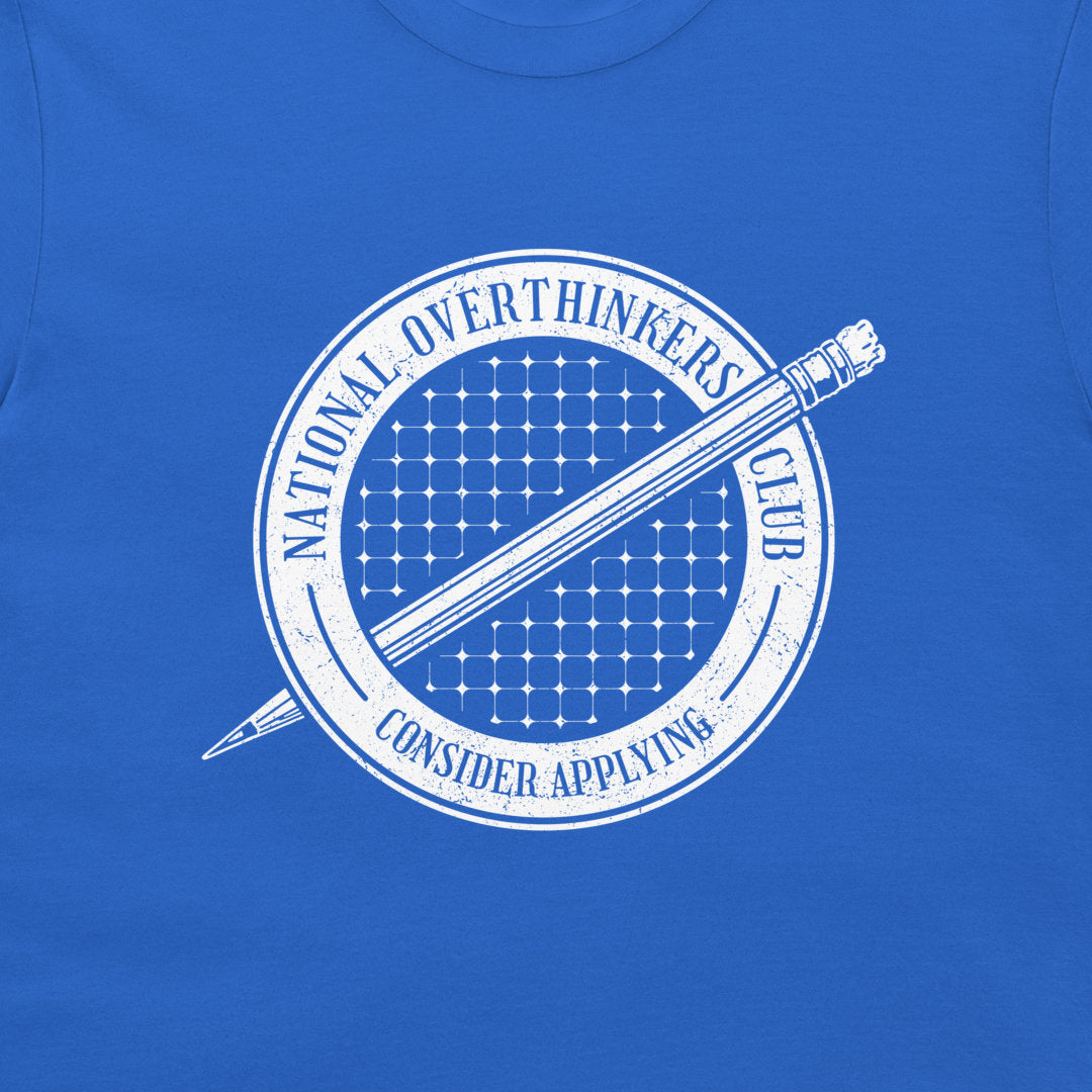 A close-up of a royal blue t-shirt featuring a white circular graphic with a pencil and the text 'NATIONAL OVERTHINKERS CLUB CONSIDER APPLYING'.