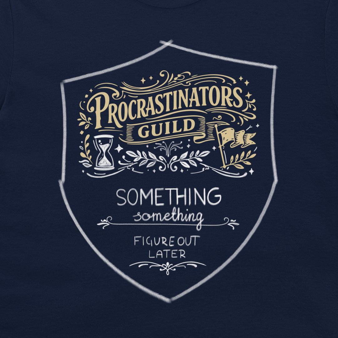 A close-up of a navy blue t-shirt featuring a white and gold graphic print on the chest. The graphic is a shield-shaped emblem with the text 'PROCRASTINATORS GUILD' in gold and white, and 'SOMETHING FIGURE OUT LATER' in white below it.