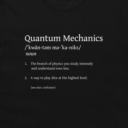 A black t-shirt featuring a white printed graphic that defines 'Quantum Mechanics' in a dictionary style with a humorous second meaning.