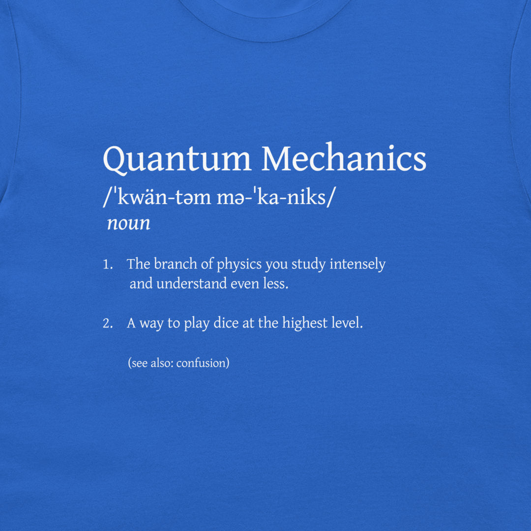 A close-up of a blue T-shirt with white printed text defining 'Quantum Mechanics' in a dictionary style.