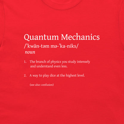 A close-up of a bright red t-shirt featuring white printed text that defines 'Quantum Mechanics' in a dictionary style with humorous, nonsensical dictionary entries.